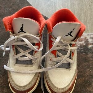White and Orange High-Top Sneakers with Bold Design